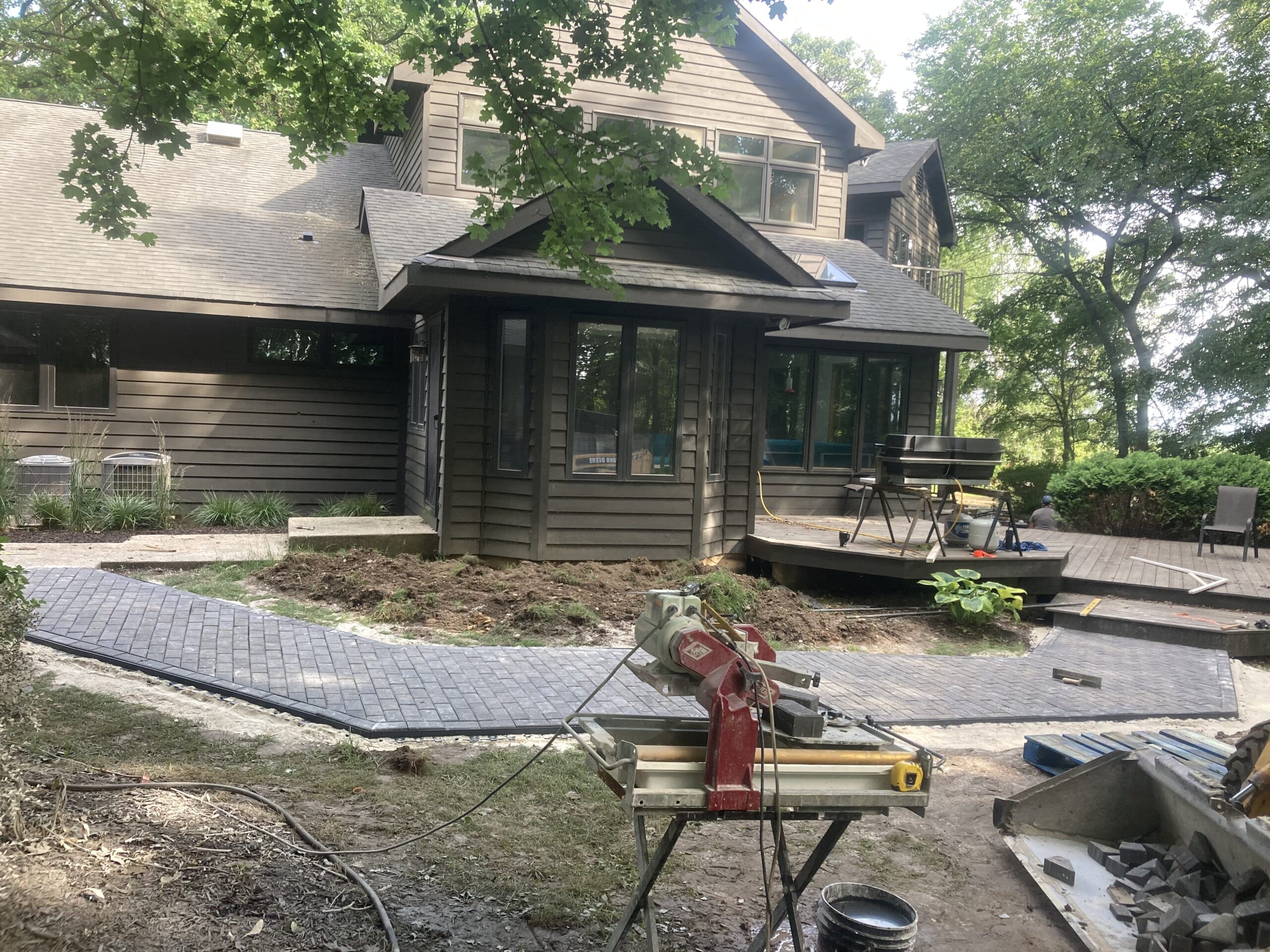 Paver walkway and patio connection, lakeside home