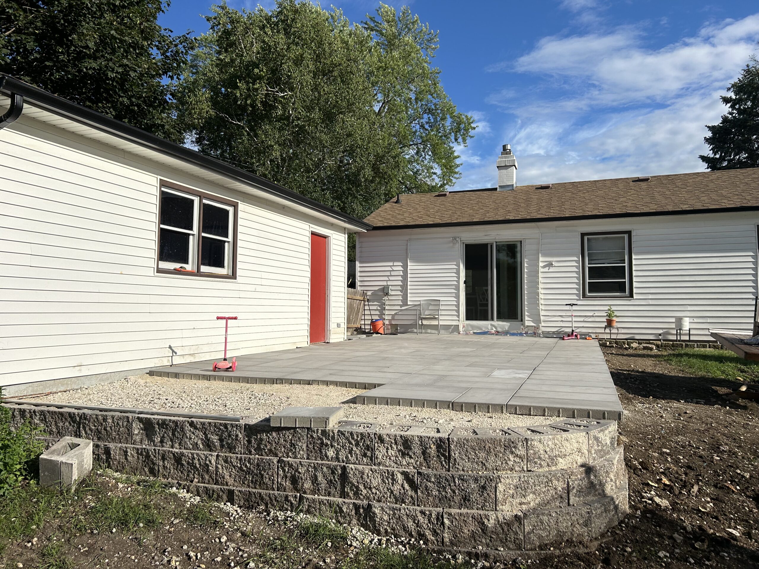 Paver patio with limestone block retaining wall