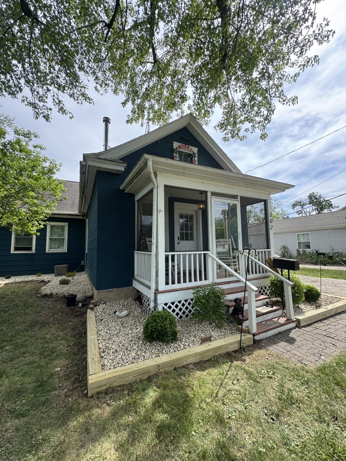 Striped lawn and fresh mulch beds, brick estate home